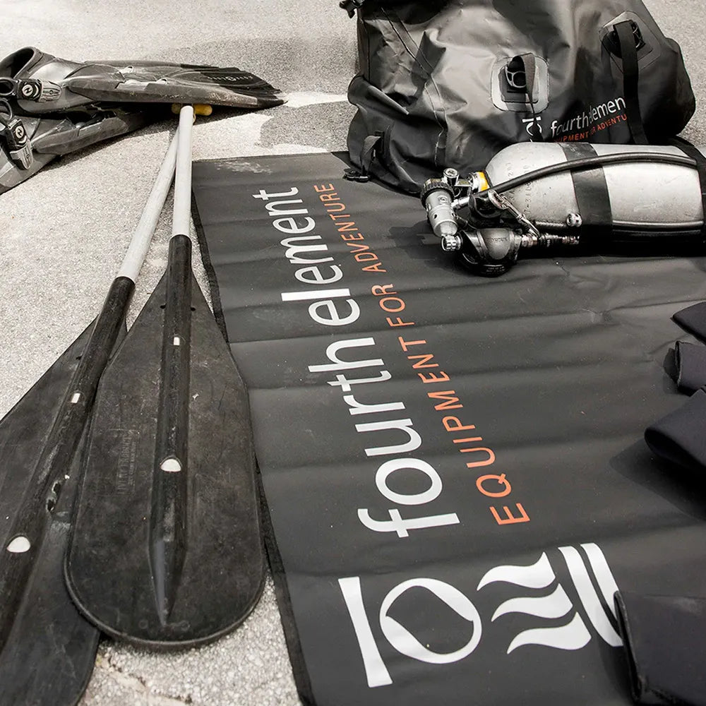 Paddle and equipment on a Fourth Element mat.