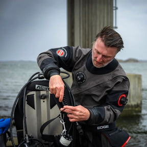 Person in drysuit adjusting Agir Black Bird Wing System
