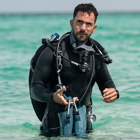 Diver in Fourth Element Xenos ARC 3mm Wetsuit standing in clear water